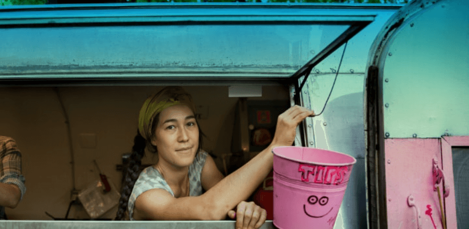 Woman opening a window with a pink bucket