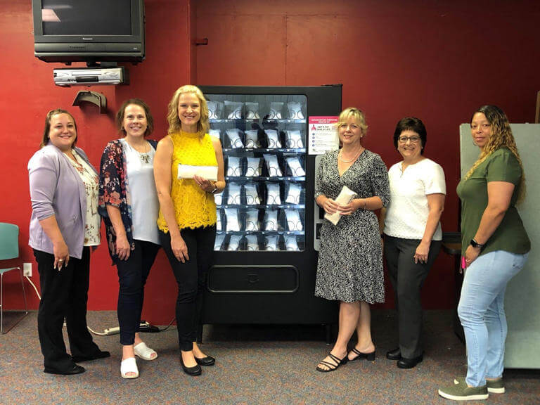 the team standing in front of the vending machine