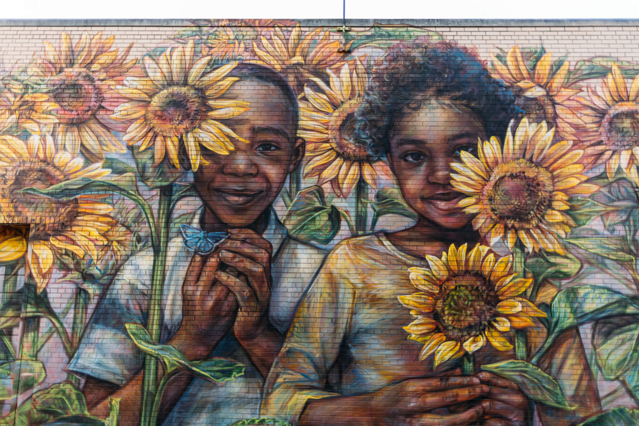mural of two children in a sunflower garden